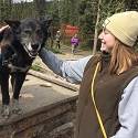 Becca pets a happy Denali sled dog.